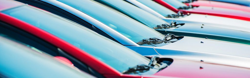 Row of colorful vehicles parked side by side.